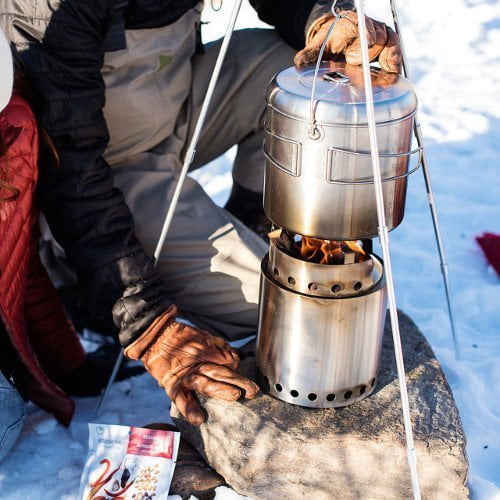 Man Crouching with his Solo Stove Pot 4000