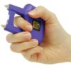 Spike Stun Gun Purple in hand sparking