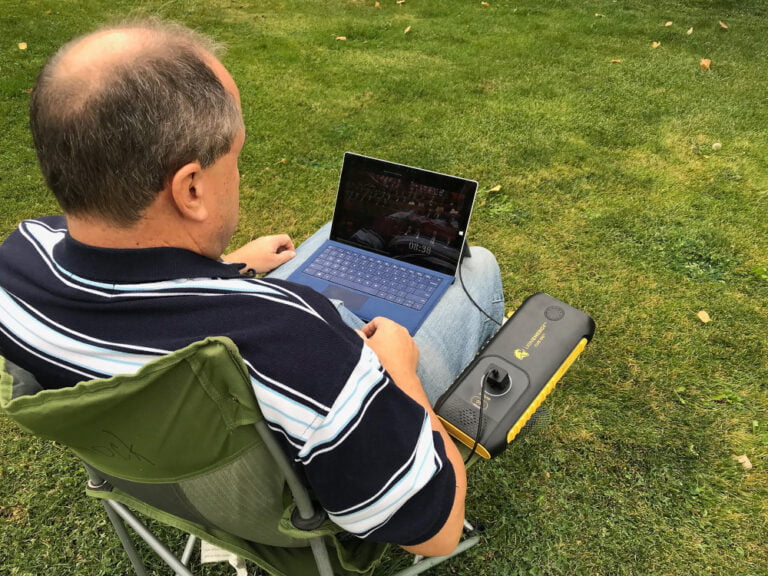 Lion Cub GO Portable Generator powering laptop in yard